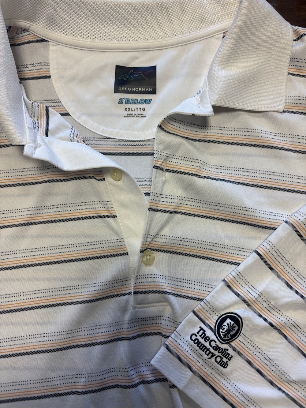 Greg Norman 2 below Golf shirt
** Carolina Country Club ** logo on left arm